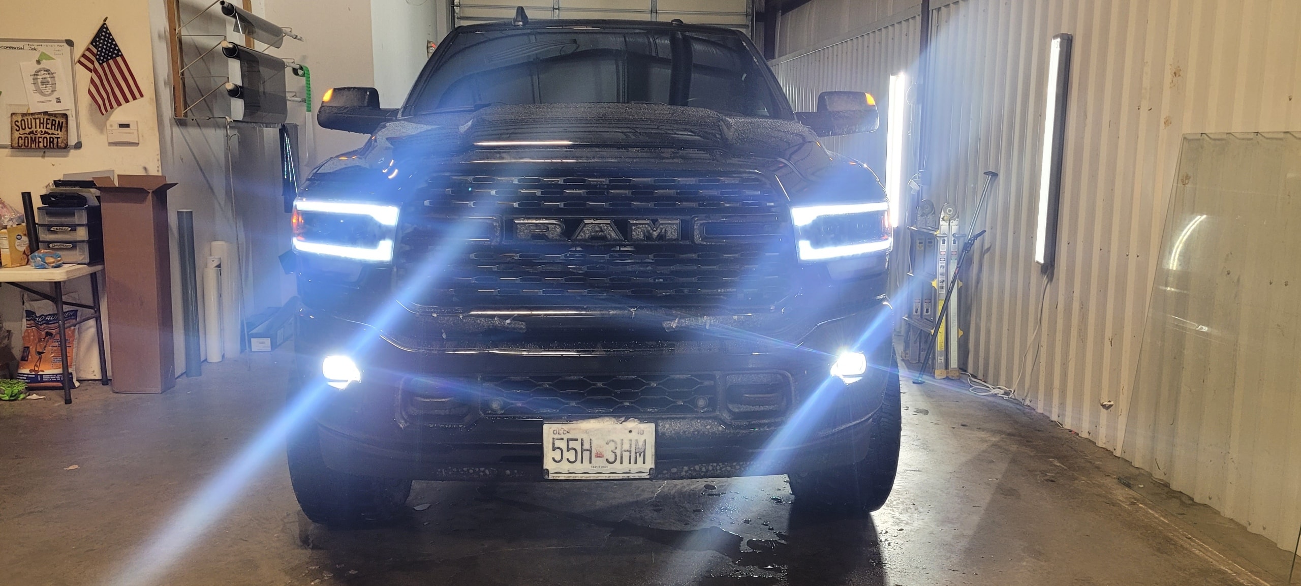 Black Ram 1500 in shop with LED headlights