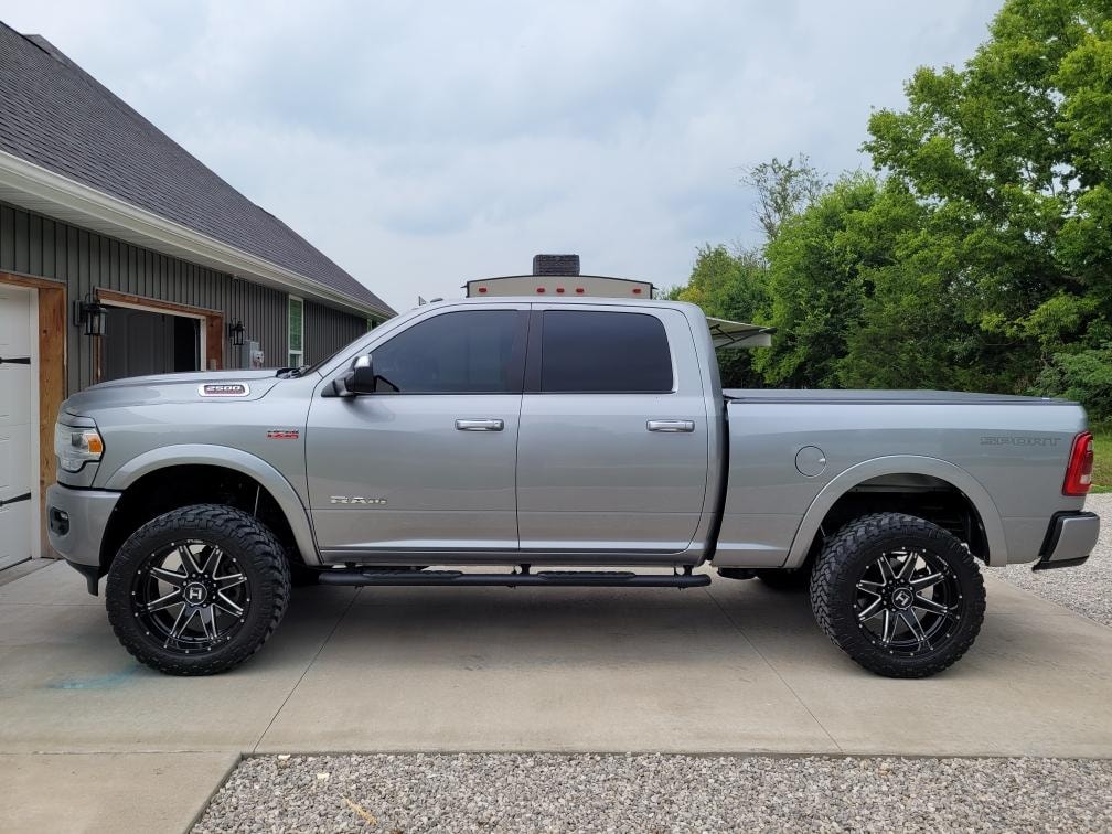 Silver Ram truck with headlights on in garage