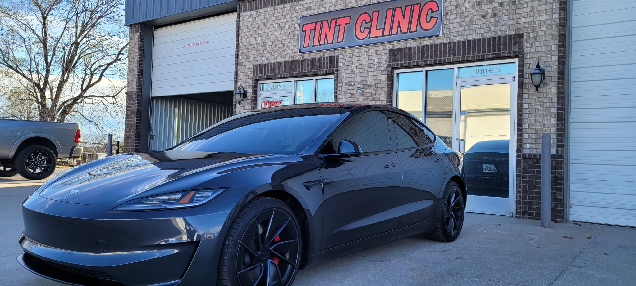 Black Tesla parked at Tint Clinic