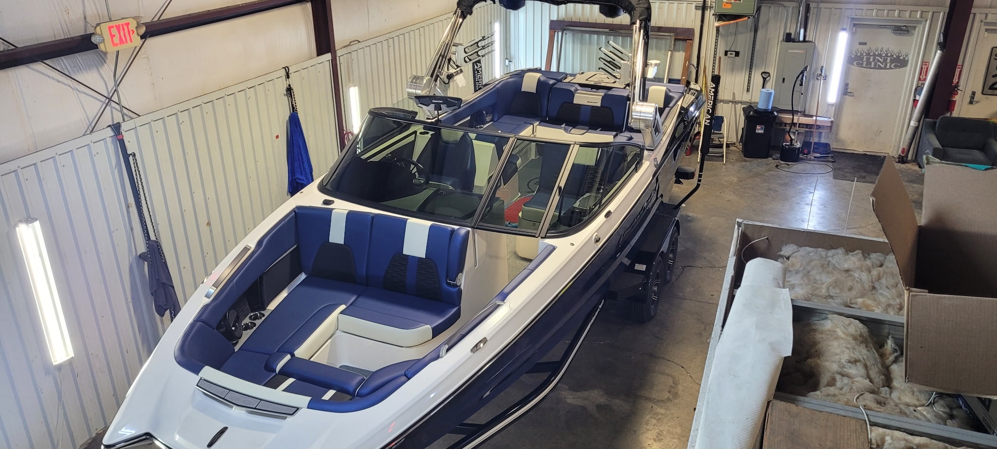 Speedboat with blue seats in storage facility