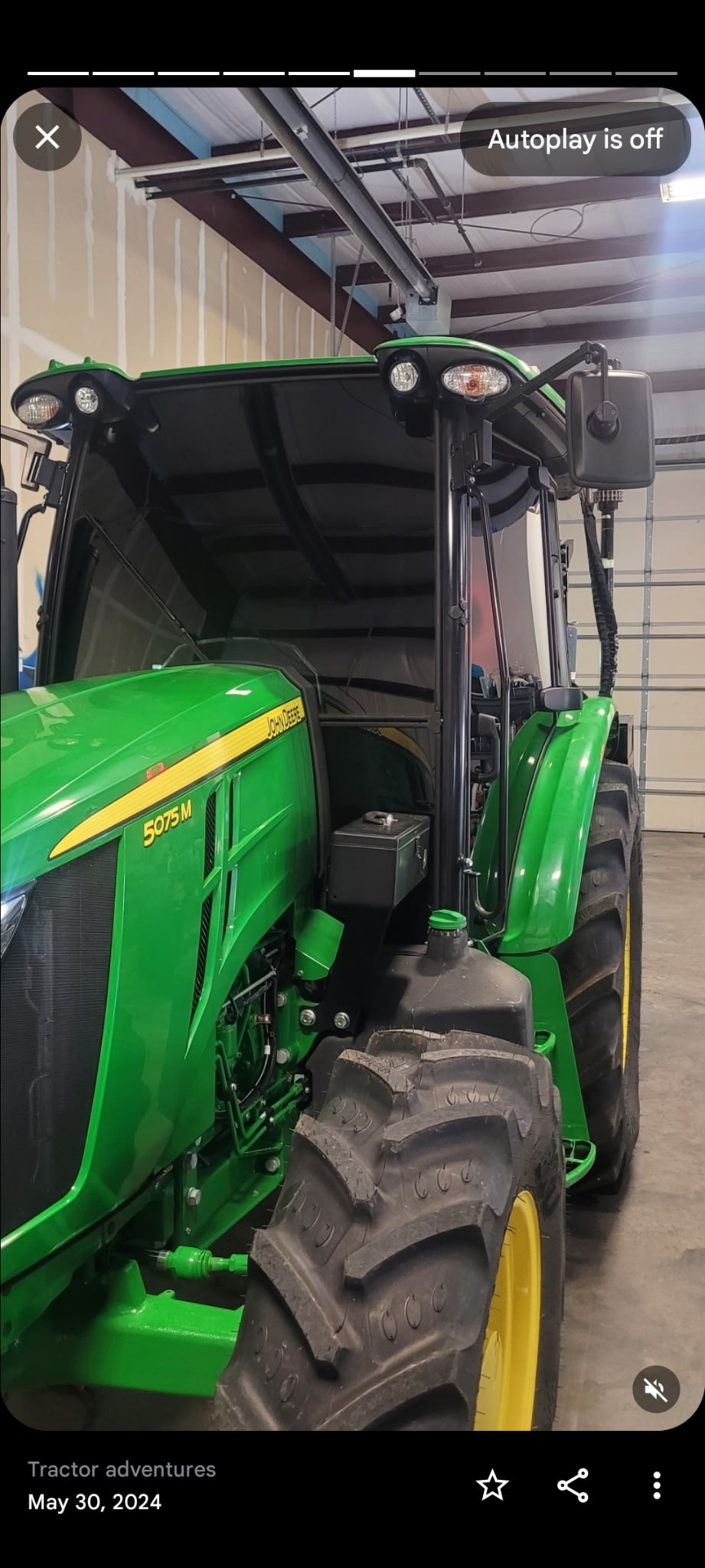 Green John Deere tractor open cab
