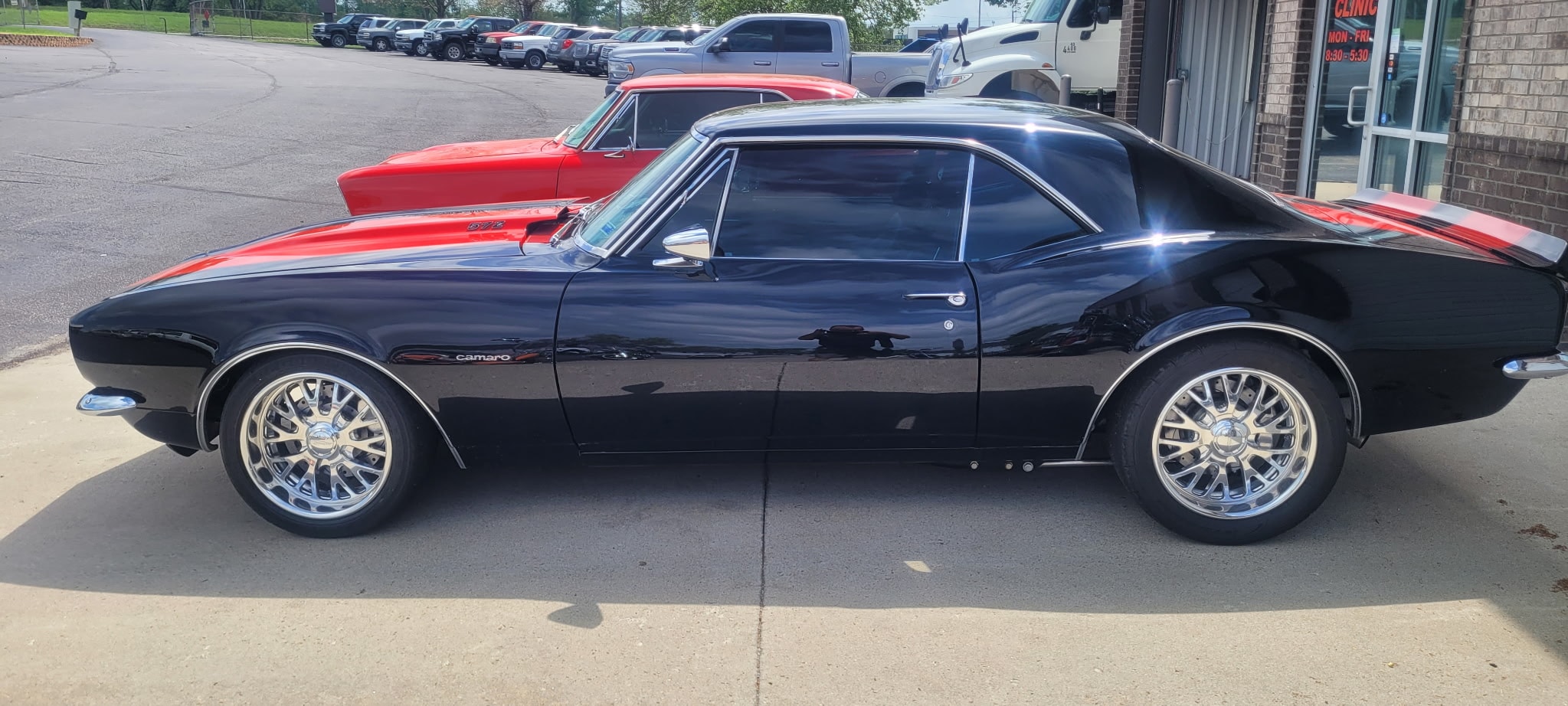 Black Camaro muscle car in parking lot